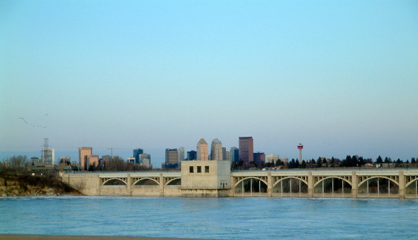 Photograph of Glenmore Reservoir spillway gates with Calgary downtown in background