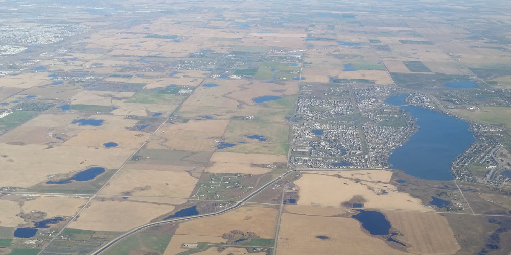 View over chestermere showing irrigation, municipal, and industry activity